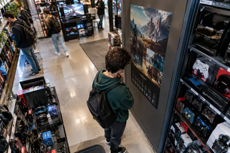 Player reviewing monthly gaming habits beside a controller and notebook